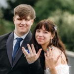 Kayleigh and Deacon showing off their wedding rings to the camera